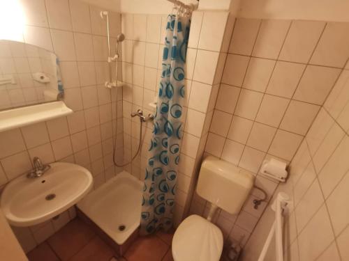 małą łazienkę z toaletą i umywalką w obiekcie Platán üdülő w mieście Balatonlelle