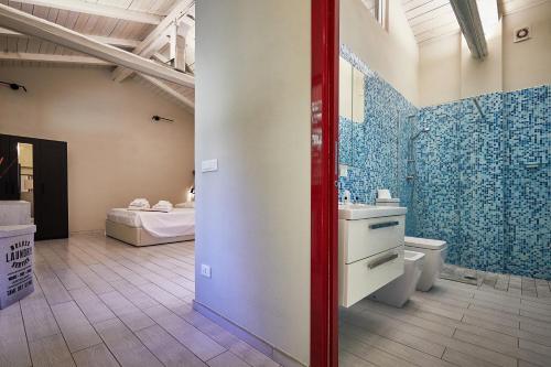 a bathroom with a sink and a toilet in a room at CARLOTTA FIERA SUITE in Bologna