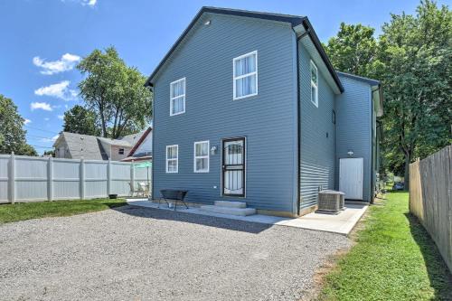 a blue house with a fence in a yard at Fort Wayne Getaway - Family and Pet Friendly! in Fort Wayne