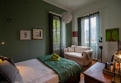 a bedroom with a bed and a couch and a chair at Villa Art'è in Locarno