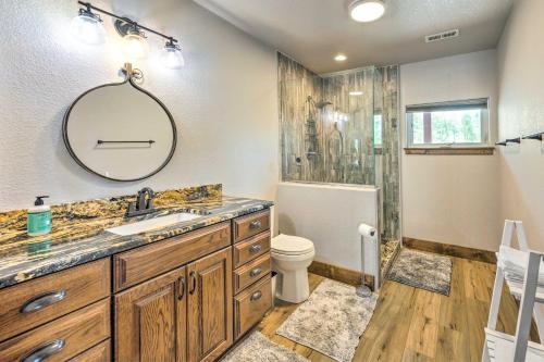 a bathroom with a sink and a toilet and a mirror at Hot Tub and Mtn View Cripple Creek Retreat! in Cripple Creek