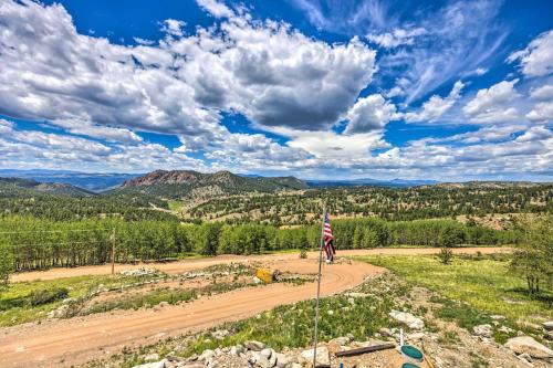 a person riding a bike down a dirt road at Hot Tub and Mtn View Cripple Creek Retreat! in Cripple Creek