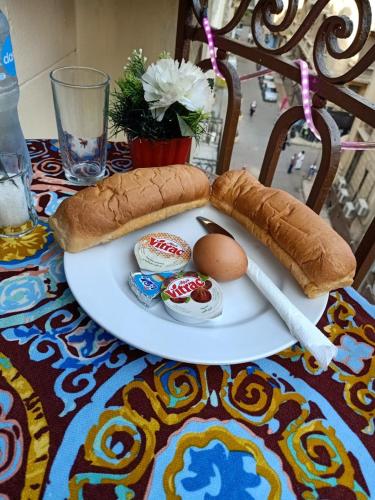 a plate with an egg and a sandwich on a table at New One Hotel in Cairo