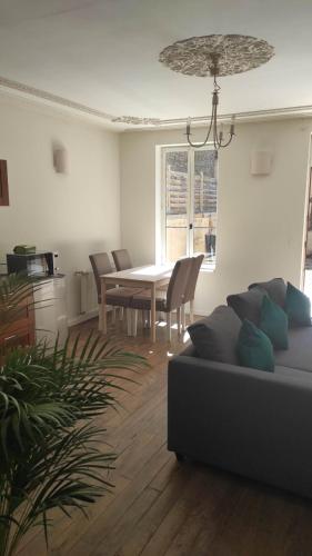 a living room with a couch and a table at AUBIGNY SUR NERE in Aubigny-sur-Nère