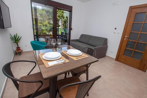 a dining room with a wooden table and chairs at Zia Apartments in Bar