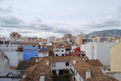 a view of a city with buildings and roofs at Hostal Italia in Fuengirola