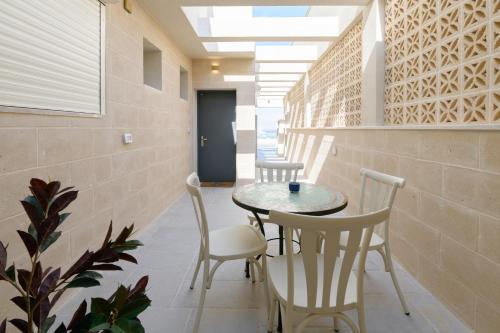 a hallway with a table and chairs in a building at PRINCES of the Dead Sea by CROWN in Neve Zohar