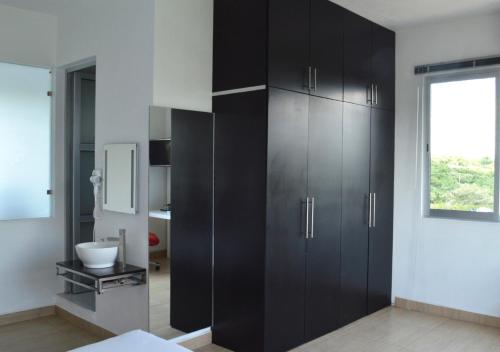 a black cabinet in a room with a window at Rancho Macloy Hotel Spa & Social Events in Yautepec