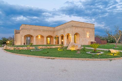 a large brick building with a garden in front of it at TENUTA DOROLIVO in Otranto