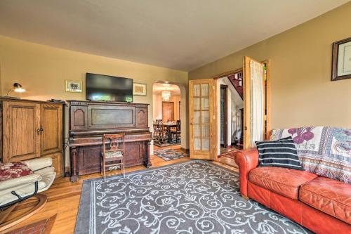 a living room with a couch and a flat screen tv at Sault Ste Marie Historic Home, Walk to Town! in Sault Ste. Marie