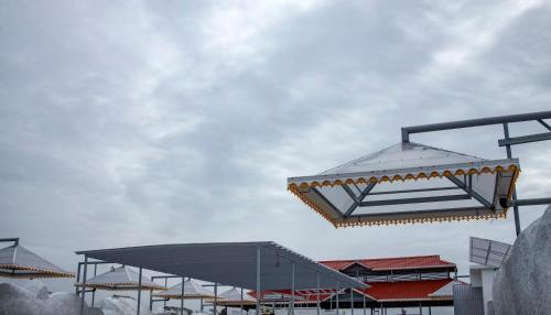 a group of buildings with a cloudy sky in the background at KKM International in Kuzhittura