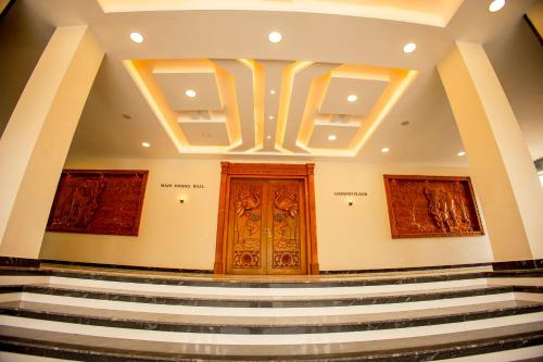 a set of stairs in a building with a wooden door at KKM International in Kuzhittura