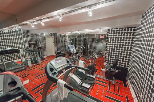 a gym with a lot of exercise equipment in it at Ameritania at Times Square in New York