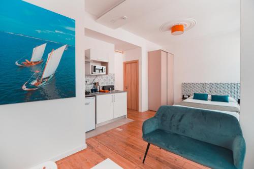 ein Schlafzimmer mit einem Bett und einem blauen Sofa in der Unterkunft Harbour49 - AVEIRO FLATS & SUITES in Aveiro