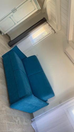 a blue couch in a room with a window at Stella Marina in Olbia