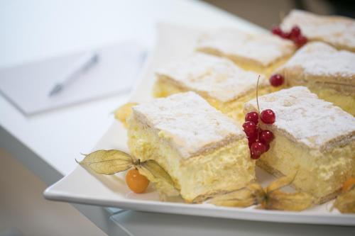 a plate of food with cake and fruit on it at R&R Residenzen HOTEL in Mitterbach