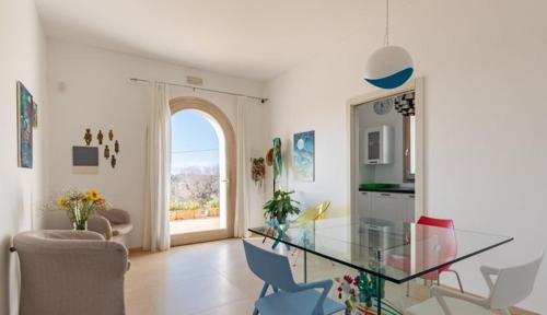 a living room with a glass table and chairs at Agriturismo Spirdo in Ruffano