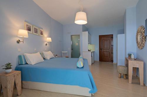 a blue bedroom with a large blue bed in it at Stella in the Village - Junior Studio Sea View in Plakias