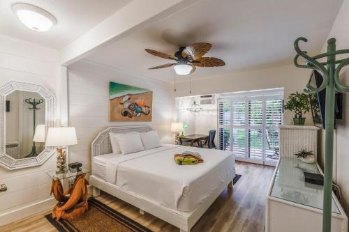 a bedroom with a bed and a ceiling fan at Puamana 30-2 in Lahaina