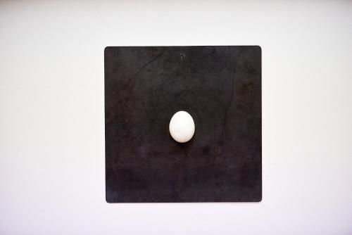 a white egg sitting on top of a black surface at Domus Maritima in Trogir