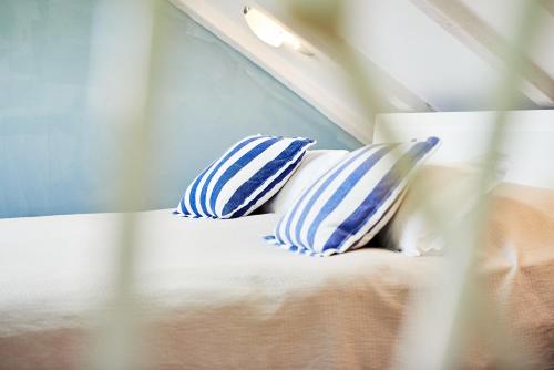 two blue and white pillows sitting on a bed at Domus Maritima in Trogir