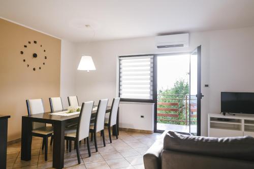a living room with a dining room table and chairs at Hiša Ivančič in Šared