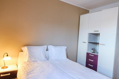 a bedroom with a bed with white pillows at Hiša Ivančič in Šared