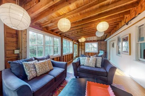 a living room with two couches and a table at Beachroad Hideout in Lobsterville