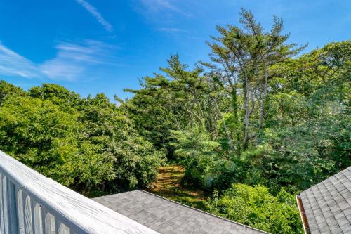 a balcony with a view of a forest at Beachroad Hideout in Lobsterville
