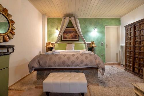 a bedroom with a large bed with a canopy at Lykovrisi Guest House in Arachova
