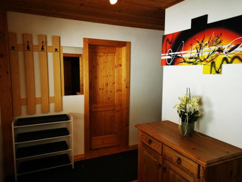 a room with a wooden door and a wooden dresser at Ferienwohnung Mühlburger in Virgen