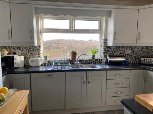 a kitchen with a sink and a window at LOCH CONNELL LODGE in Letterkenny