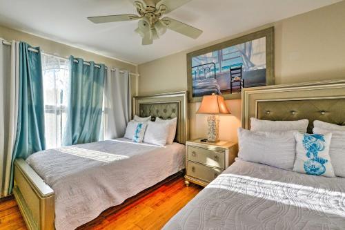 a bedroom with two beds and a ceiling fan at Brigantine Townhome Near Beaches and AC Casinos in Brigantine