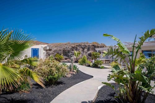 a walkway in front of a building with plants at Etti - Paradise Suite La Gaviota in Pájara