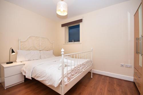 a bedroom with a white bed and a window at BAI HOUSE in London