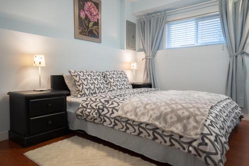 a bedroom with a bed and a window at Lovely 1BR Secondary suite with Separate entrance in New Westminster