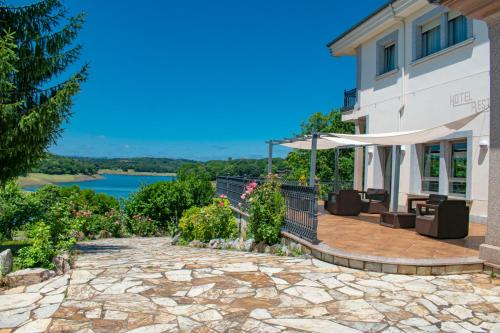 a house with a patio with a view of the water at Hermida Rural in Eirejalba