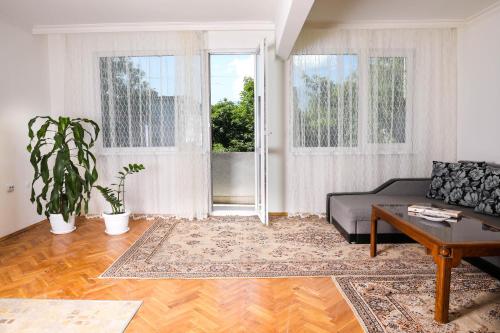 a living room with a couch and a table at Krichim Apartments,Three-Bedroom, large apartment, TOP CENTER in Sofia