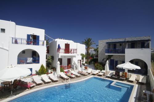 an external view of a hotel with a swimming pool at Katerina Hotel in Agios Prokopios