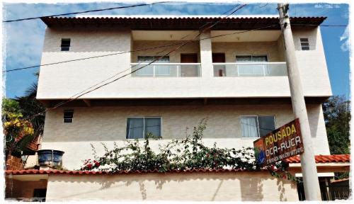 a building with a sign in front of it at Suítes de Setiba - HOSPEDARIA OCA RUCA in Guarapari