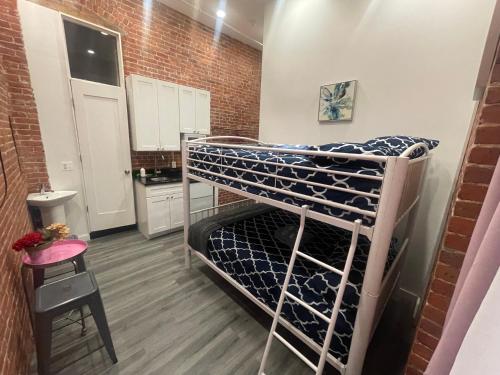 a bunk bed in a small room with a kitchen at 31 Street Broadway Hotel in New York