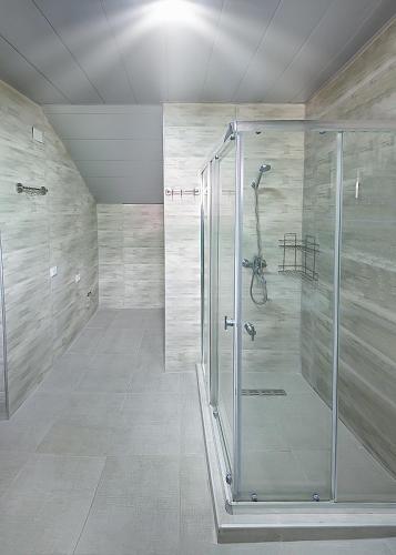 a shower with a glass door in a bathroom at Hotel Mandarinebi in Gonio