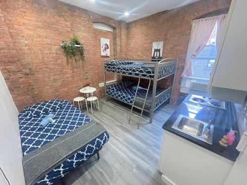 a room with two bunk beds and a brick wall at 31 Street Broadway Hotel in New York