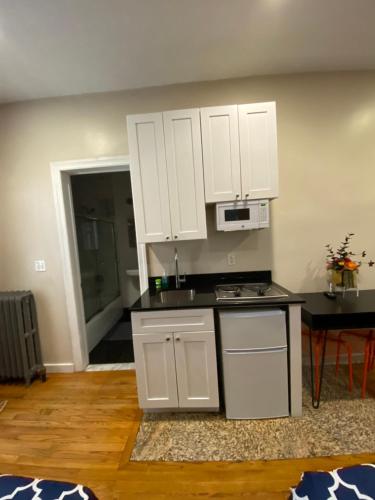 a kitchen with white cabinets and a counter top at 31 Street Broadway Hotel in New York
