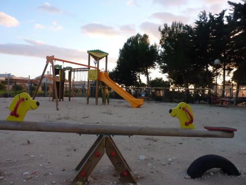 a park with a playground with a slide at Capo Scalambri in Santa Croce Camerina