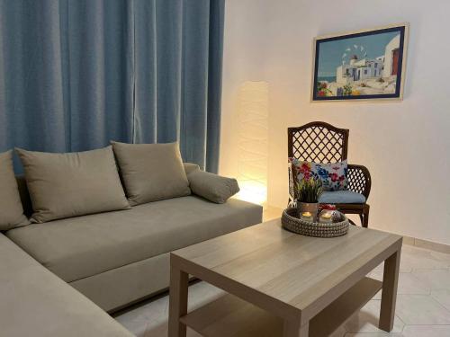 a living room with a couch and a table at Holiday House Ermionida in Thermisia