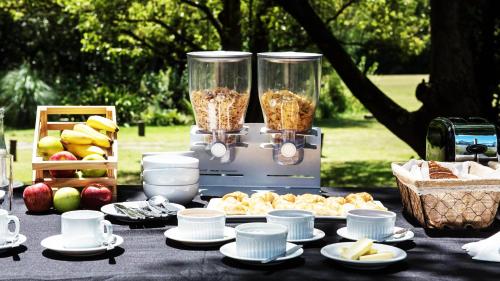 a table with food and a blender with food at Posada Mendoza by DOT Tradition in Ingeniero Maschwitz