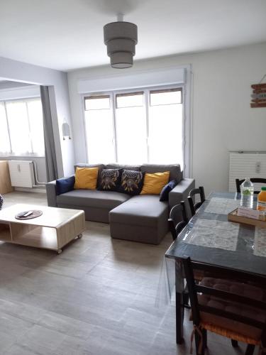 a living room with a couch and a table at Joli appartement résidentiel à Troyes in Troyes