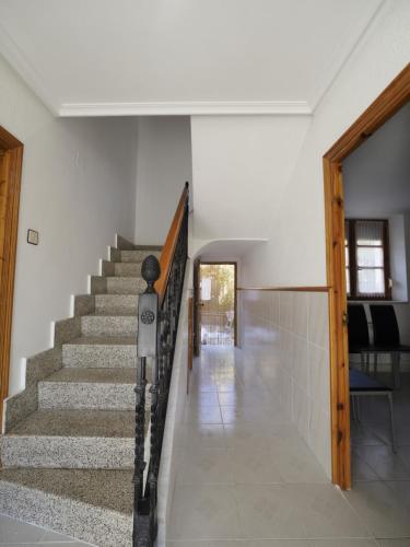 a staircase in a house with a stair case at CASA PURI - ACOGEDORA CASA CON PARKING y PATIO INTERIOR in Robles de la Valcueva