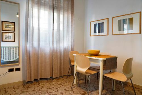 a dining room with a table and chairs and a window at Bed&Biker in Mori
